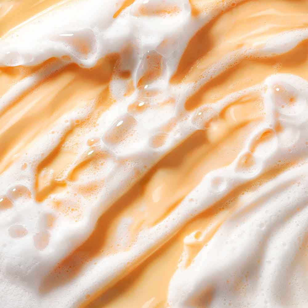 Close-up of OLEHENRIKSEN Truth Juice Gentle Glow Daily Cleanser  with white foam texture